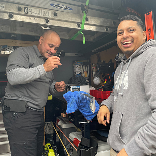 two handymen in the back of a work truck